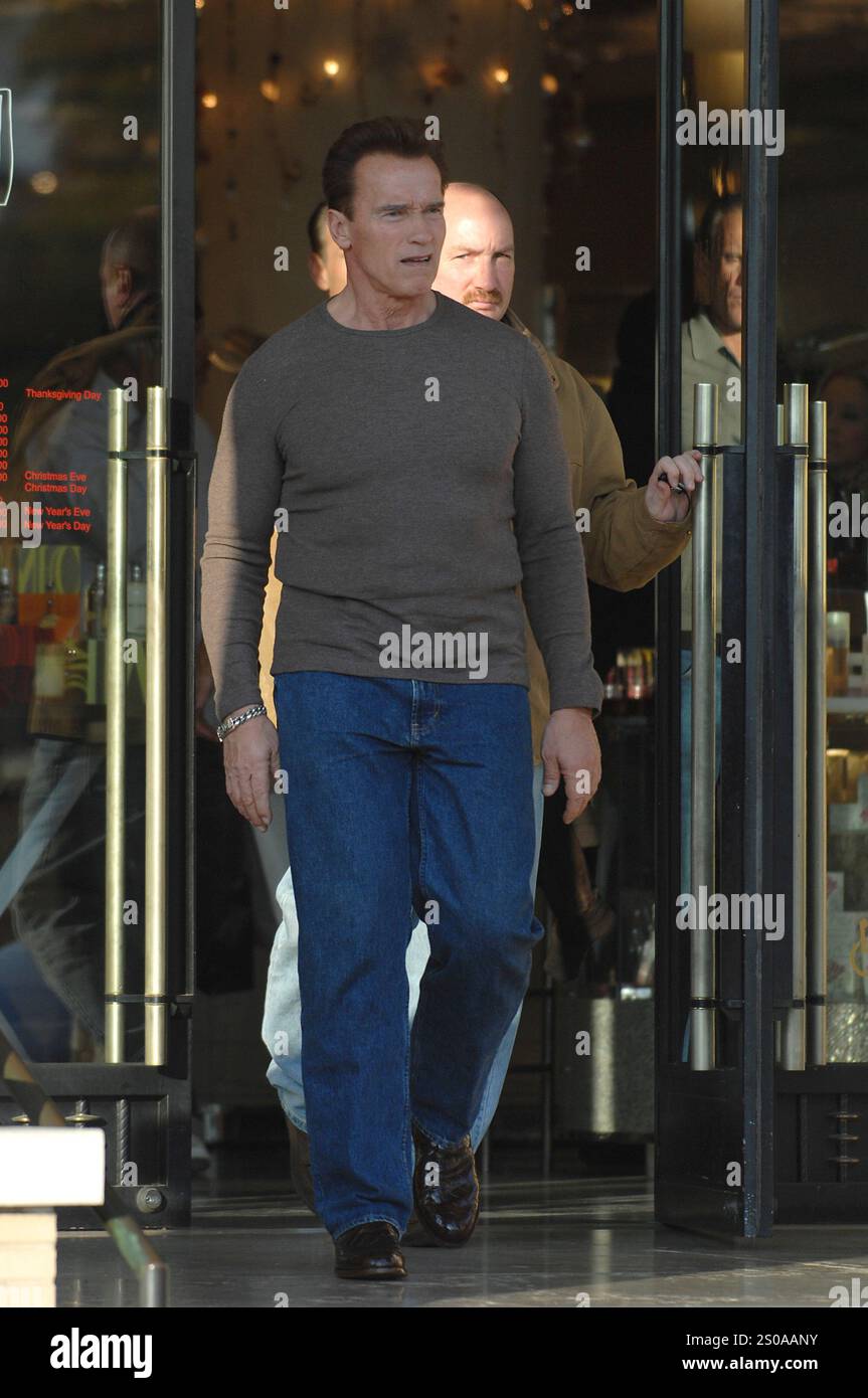 Arnold Schwarzenegger spotted in a casual outfit, stepping out in jeans and a brown top, exuding charisma and confidence. Beverly Hills Stock Photo