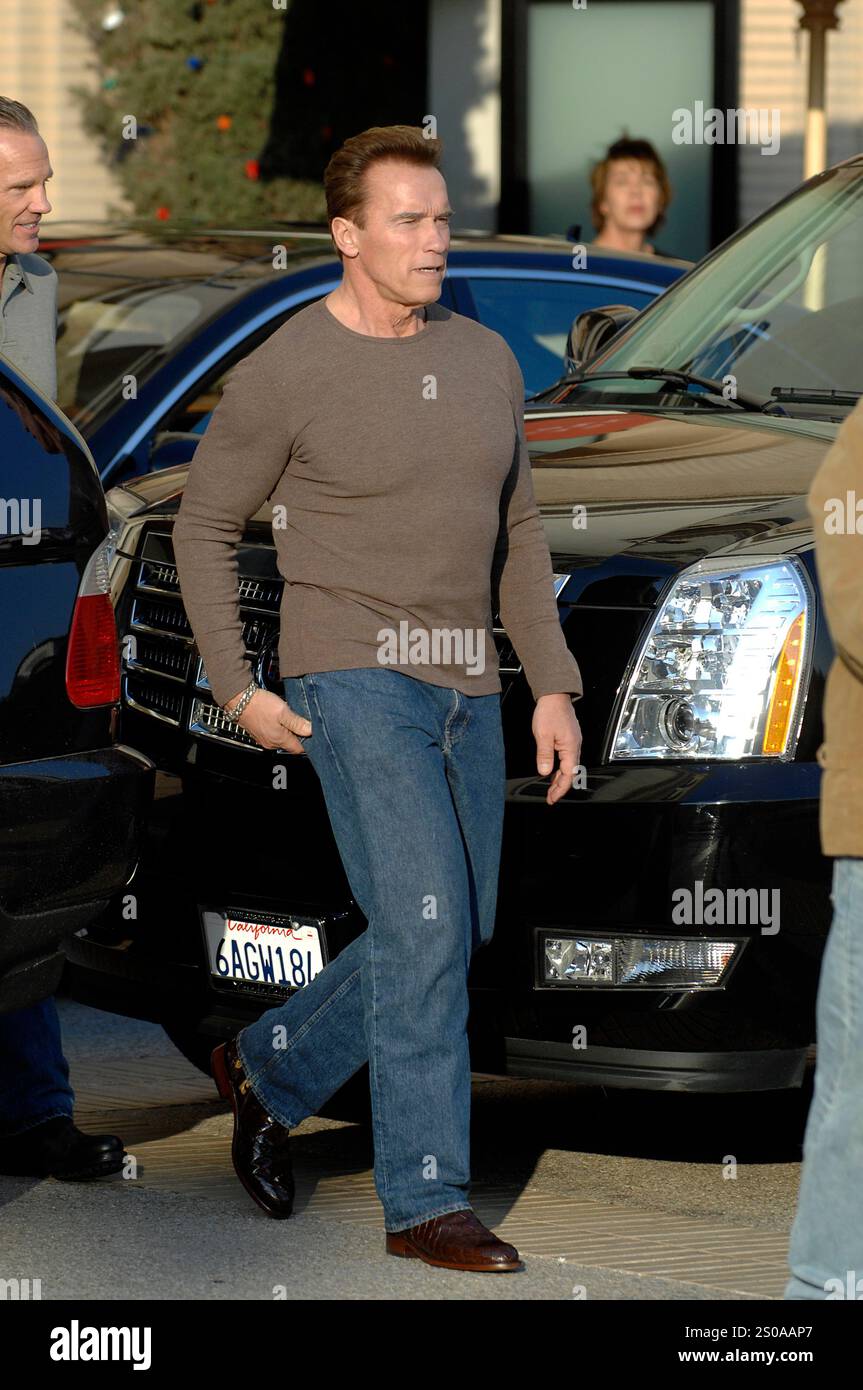 Arnold Schwarzenegger spotted in a casual outfit, stepping out in jeans and a brown top, exuding charisma and confidence. Beverly Hills Stock Photo