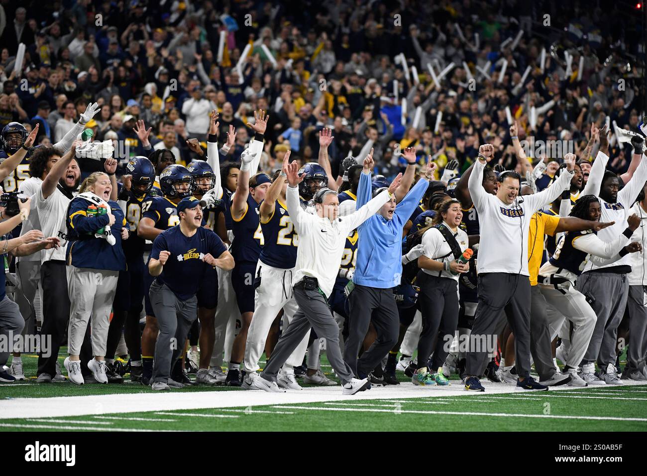 Toledo head coach Jason Candle, center front, and other team personnel
