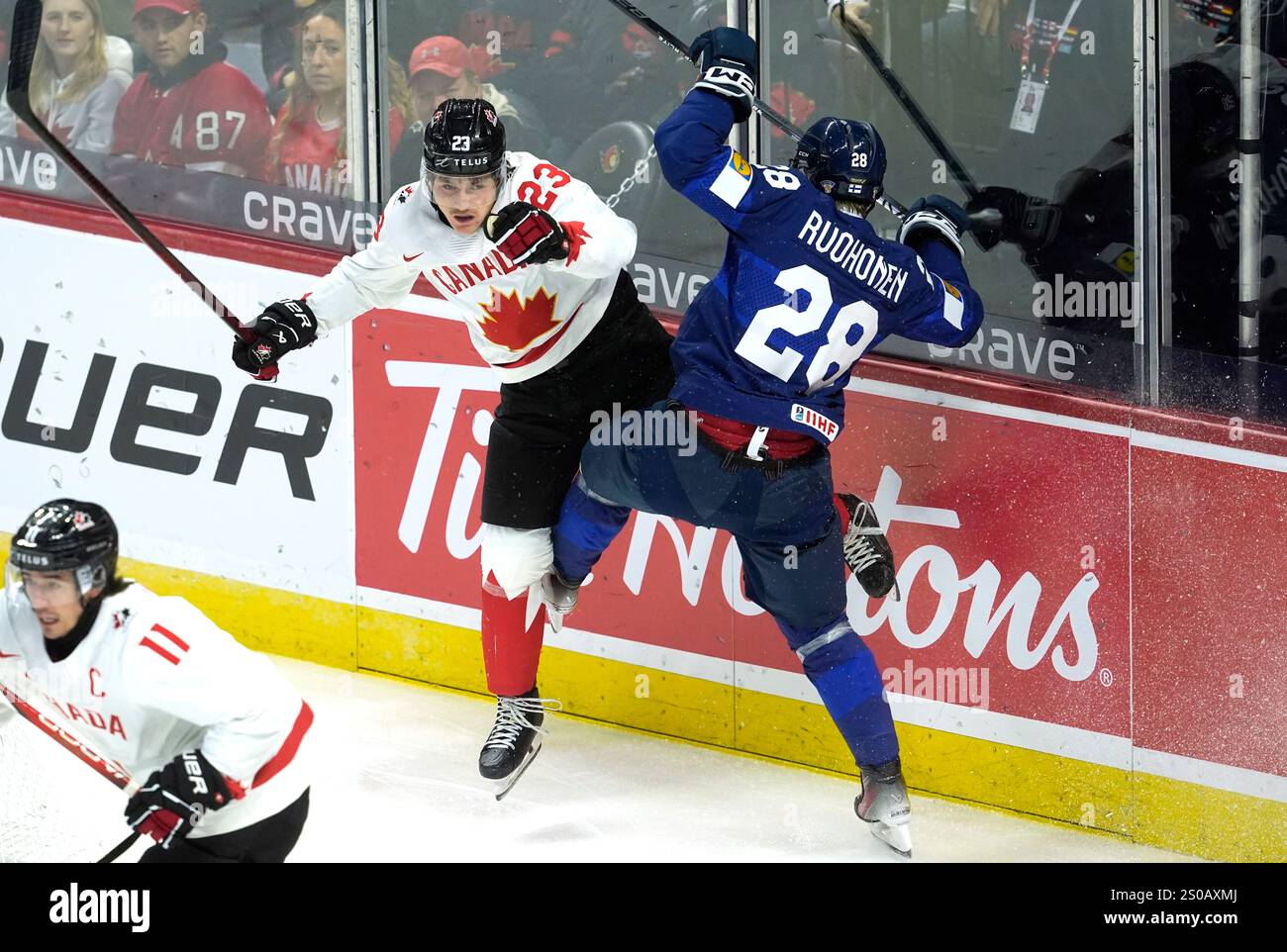 Canada forward Tanner Howe (23) collides with Finland forward Heikki