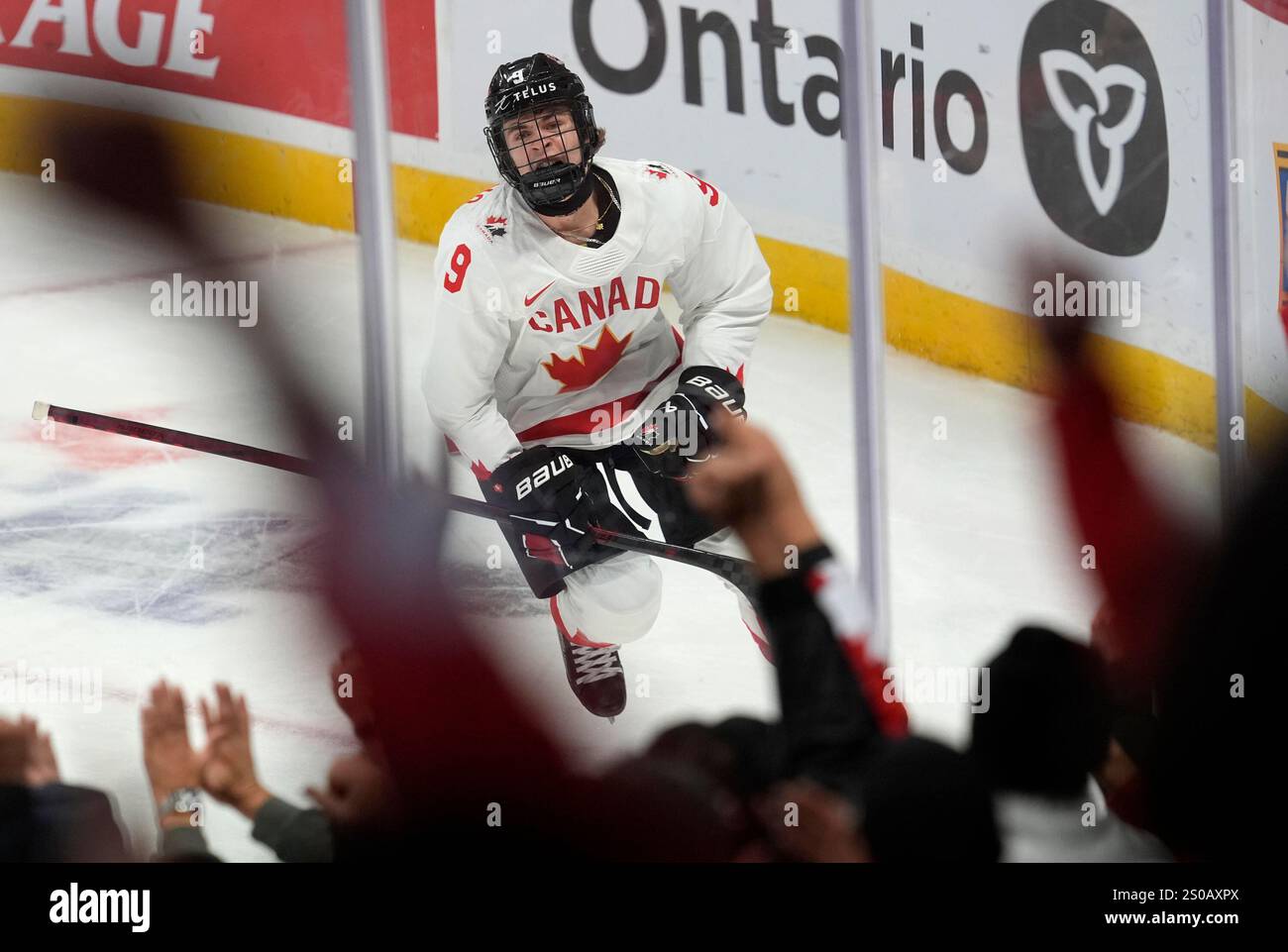 Canada forward Gavin McKenna celebrates his first goal during first