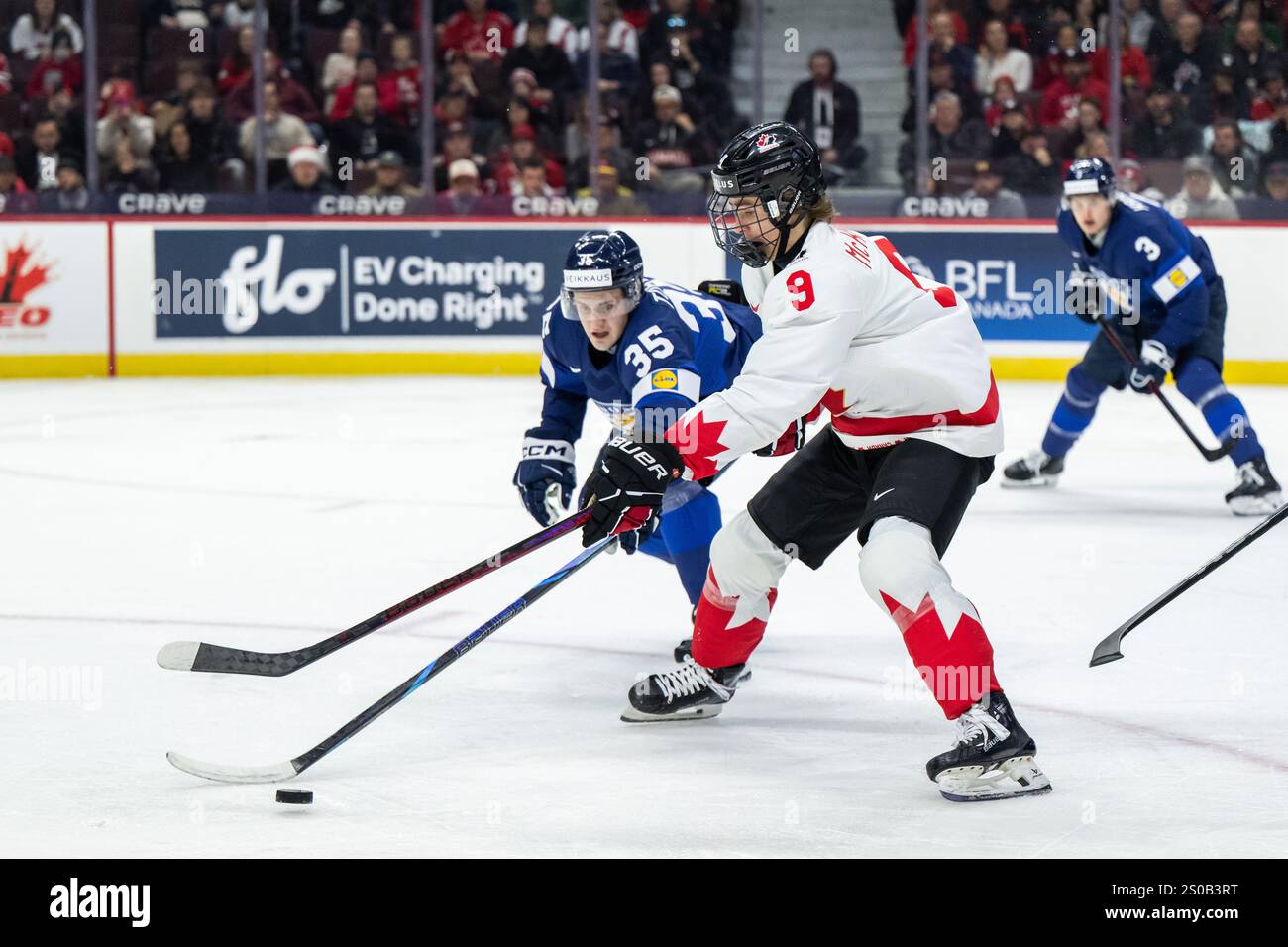 241226 Arttu Tuhkala of Finland and Gavin McKenna of Canada during the