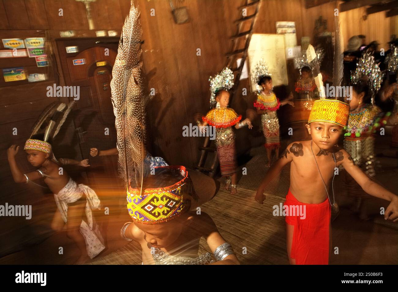 Children performing traditional welcome dance inside the longhouse of ...