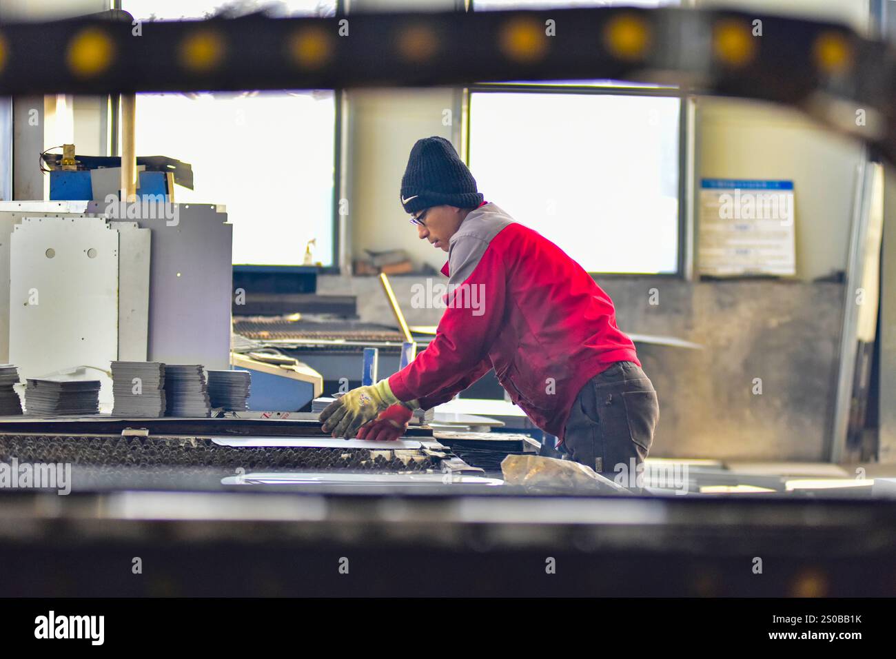 QINGZHOU, CHINA - DECEMBER 27, 2024 - A worker works in a workshop at a ...
