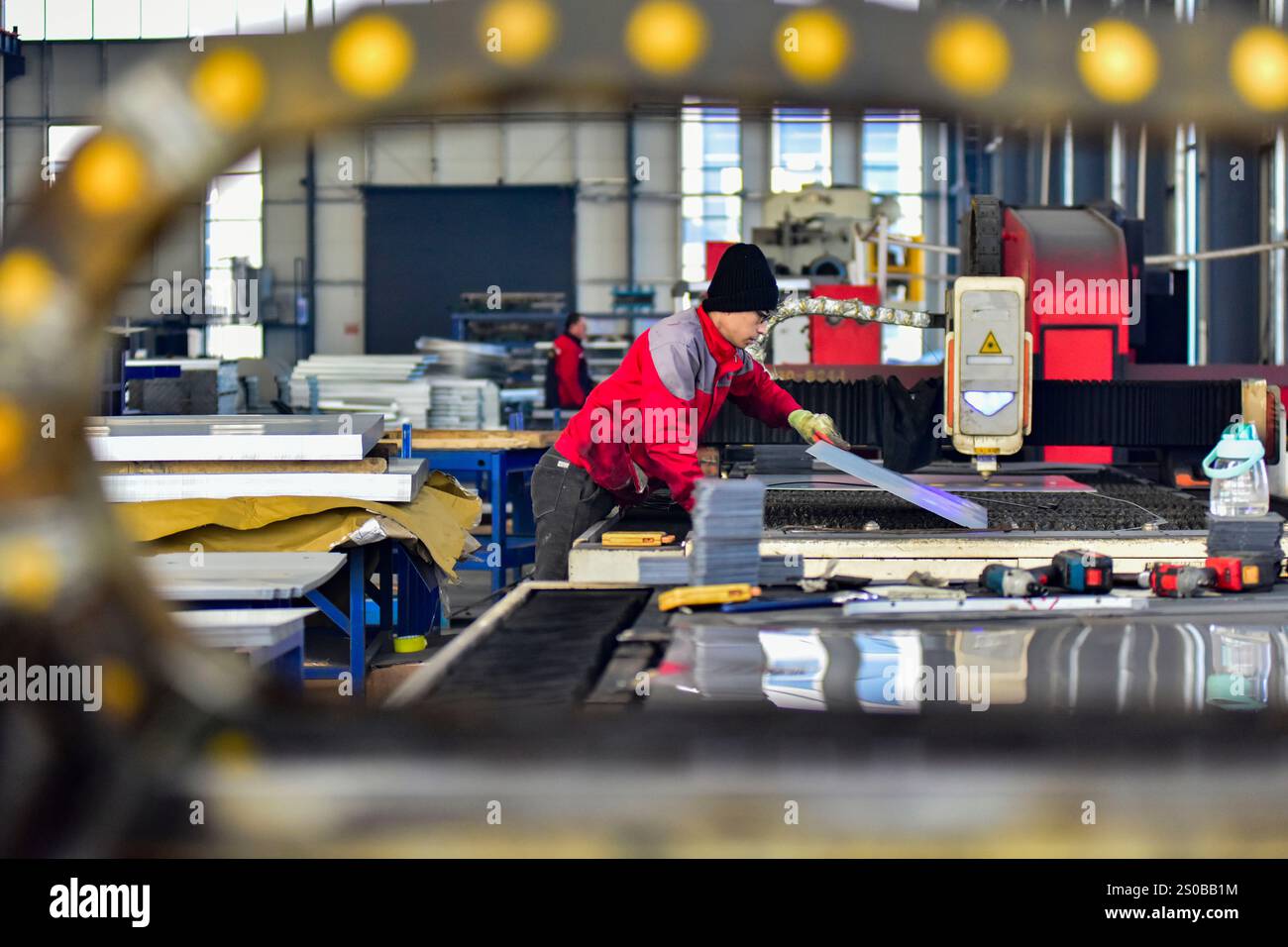 QINGZHOU, CHINA - DECEMBER 27, 2024 - A worker works in a workshop at a ...