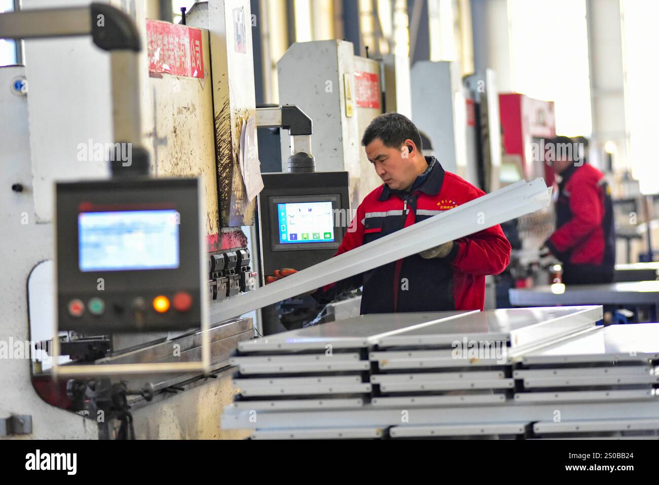 QINGZHOU, CHINA - DECEMBER 27, 2024 - A worker works in a workshop at a ...
