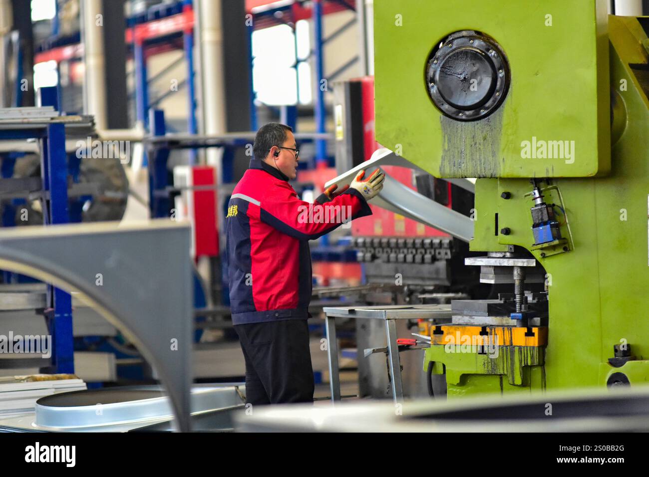 QINGZHOU, CHINA - DECEMBER 27, 2024 - A worker works in a workshop at a ...