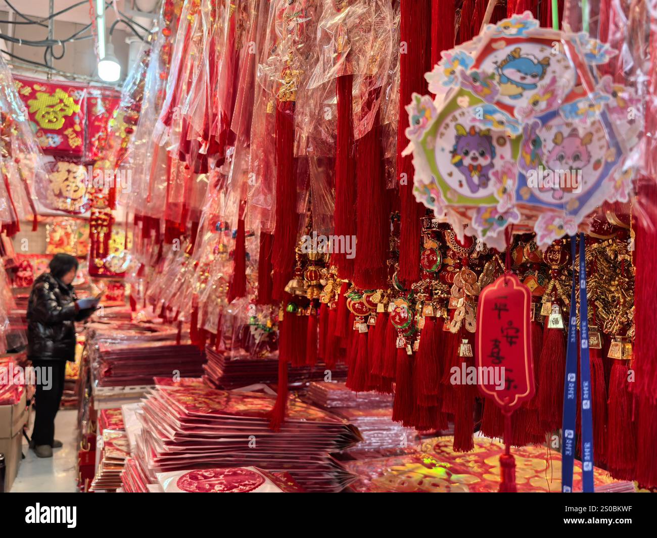 People shop Spring Festival goods at a market in Nanjing City, east