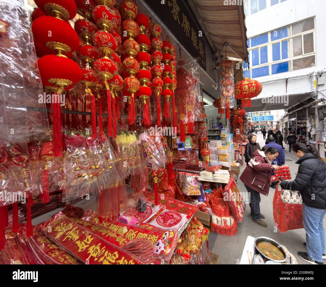 People shop Spring Festival goods at a market in Nanjing City, east