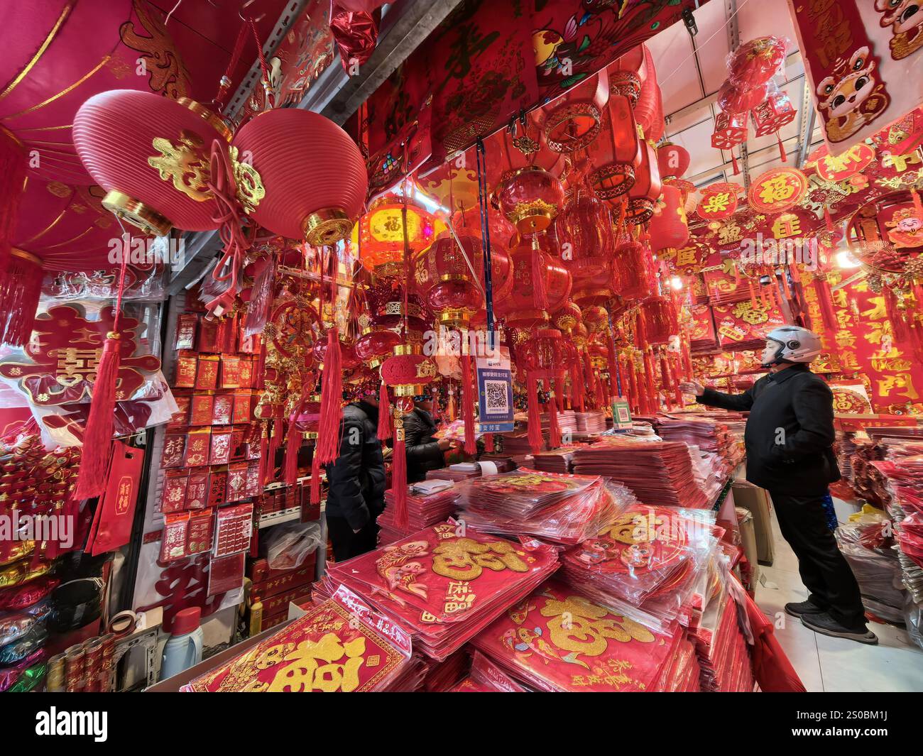 People shop Spring Festival goods at a market in Nanjing City, east