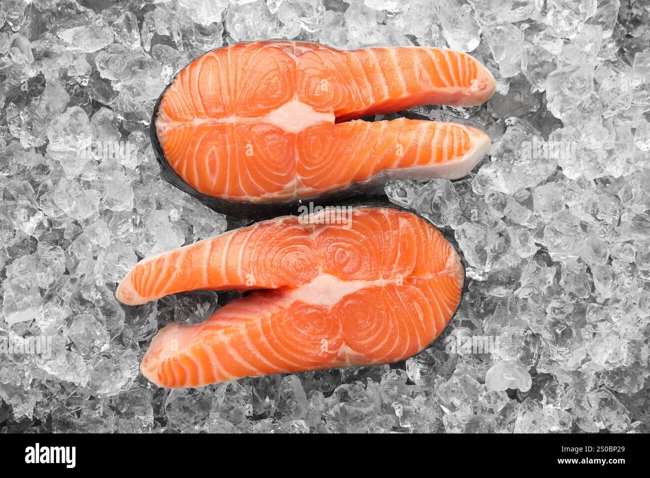 Fresh raw salmon steaks on ice pieces, top view Stock Photo - Alamy