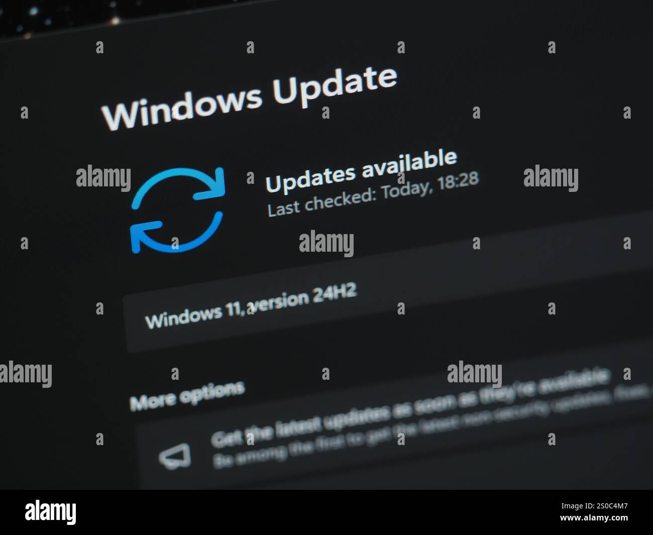 Galati, Romania - December 13, 2024: Checking for 24H2 Windows 11 updates on laptop screen close up view Stock Photo
