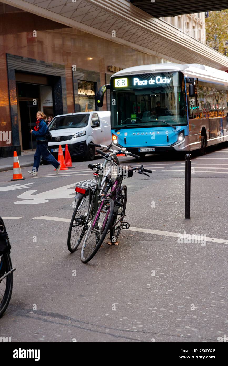 Bus Approach Bicycles parked on a city street as a bus approaches during a busy ...