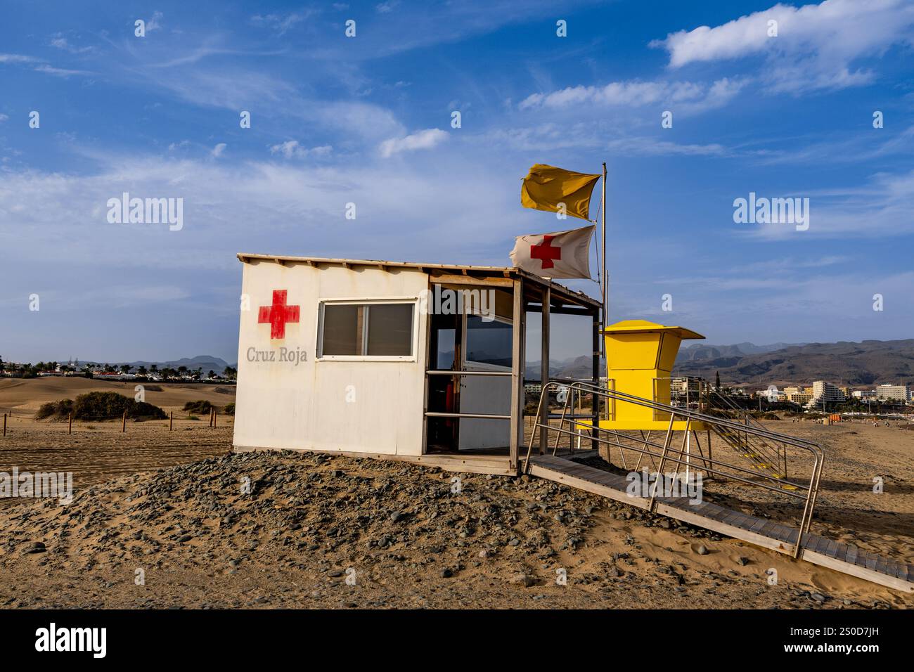 Scenic view of an iconic yellow lifeguard tower with yellow flag on ...