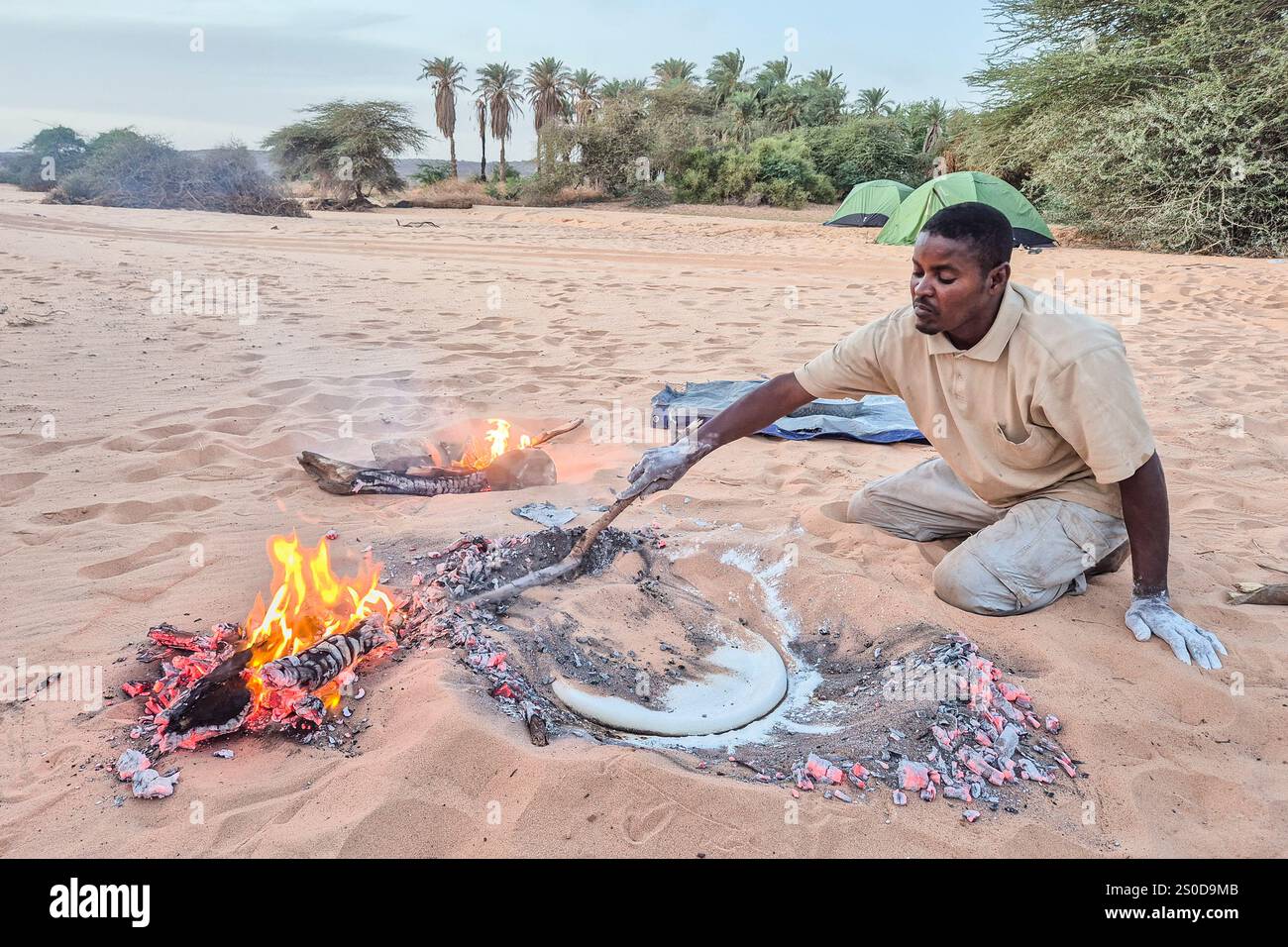 Mauritania, Azweiga, cook preparing traditional desert bread cooked ...