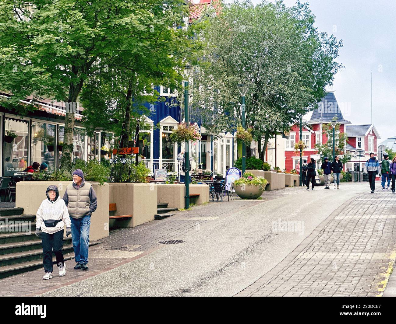 Akureyri, Iceland - 24 August 2024: people walking down the main street of Akureyri, which is the capital of the north of the island of Iceland - Smartphone Captured Stock Image