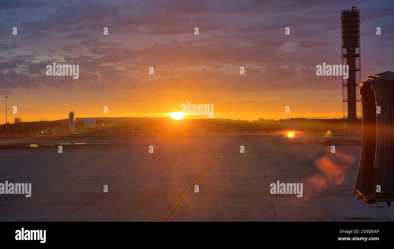 When the sun is rising, it's the most beautiful event for all living creatures, but it's special if you enjoy it from the Airport Charles de Gaulle. - Smartphone Captured Stock Image