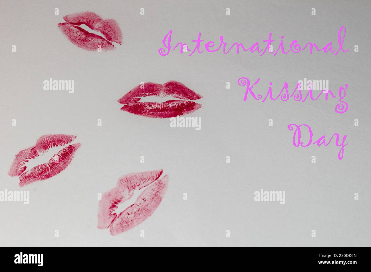 Pink and magenta lipstick imprints on a light background, international kissing day concept Stock Photo
