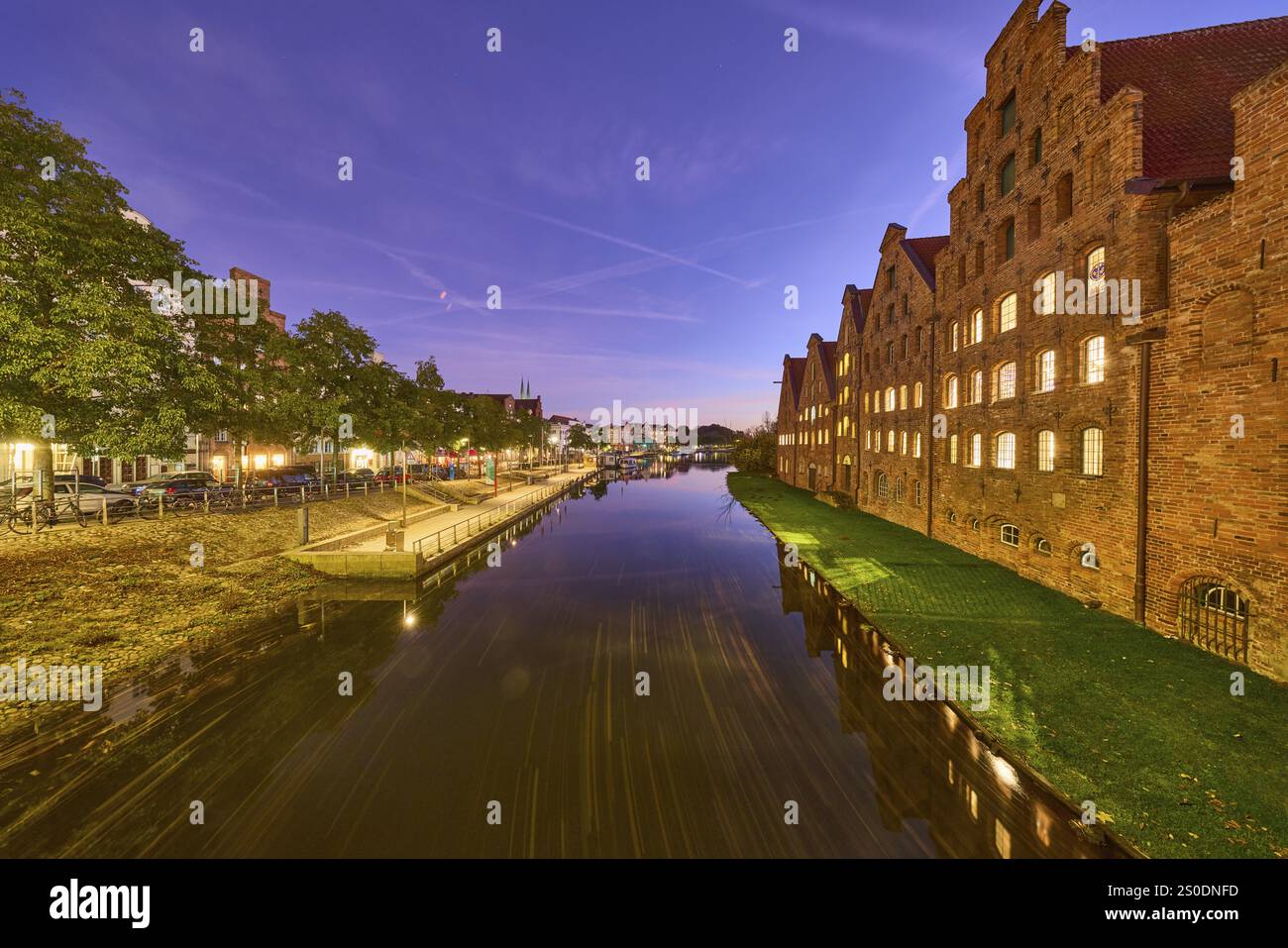 Salt warehouse, historic brick buildings, river Trave, trees, quay wall ...