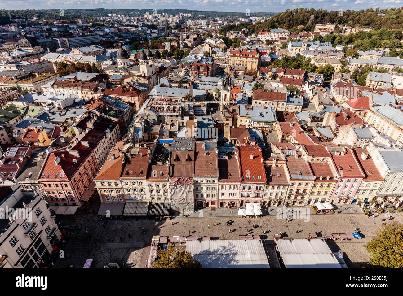 A city view with many buildings and people. Scene is lively and ...