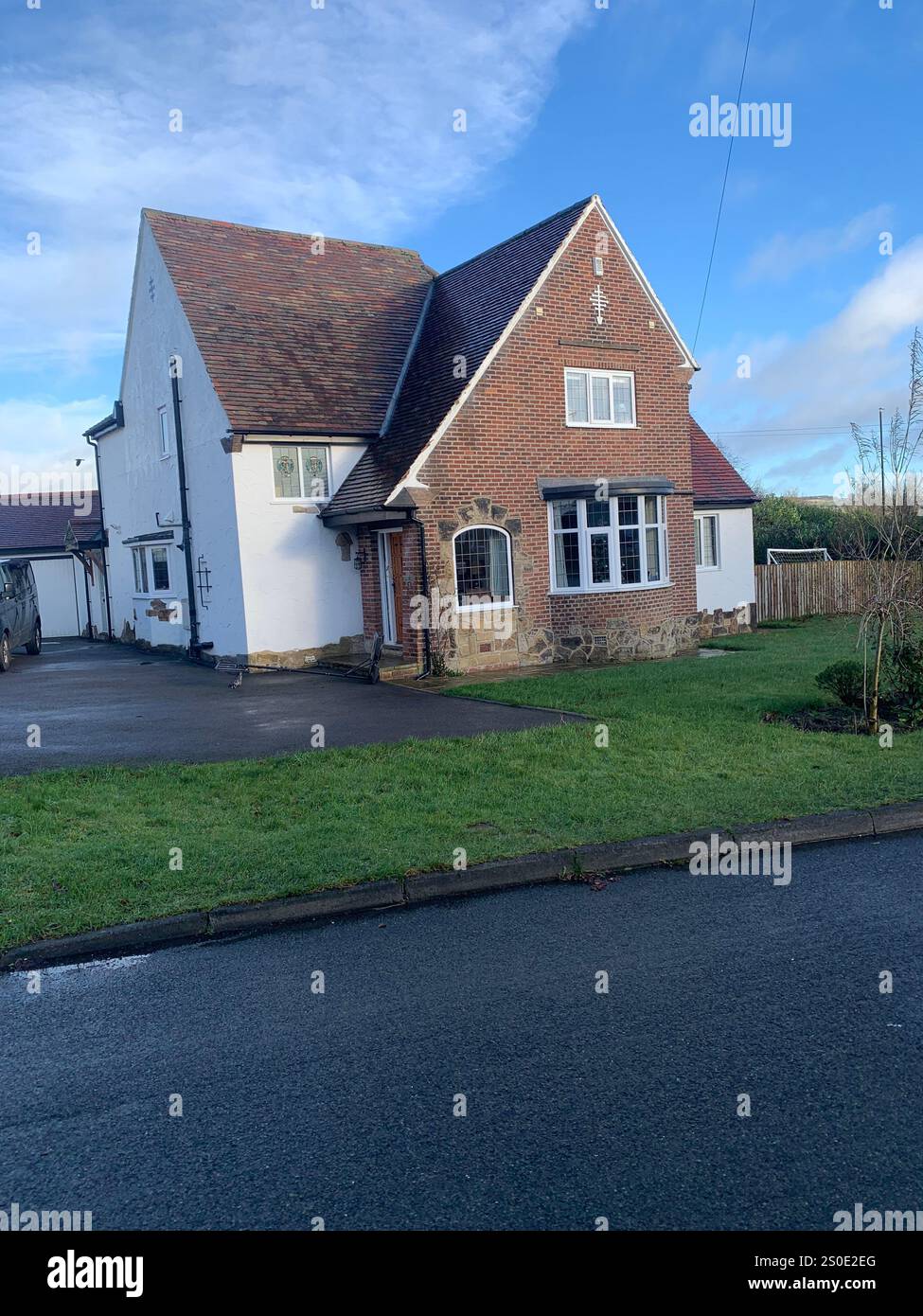 Guiseley North Yorkshire houses trees place town village countryside place sky weather Winter Christmas day place bleak clouds England old types - Smartphone Captured Stock Image