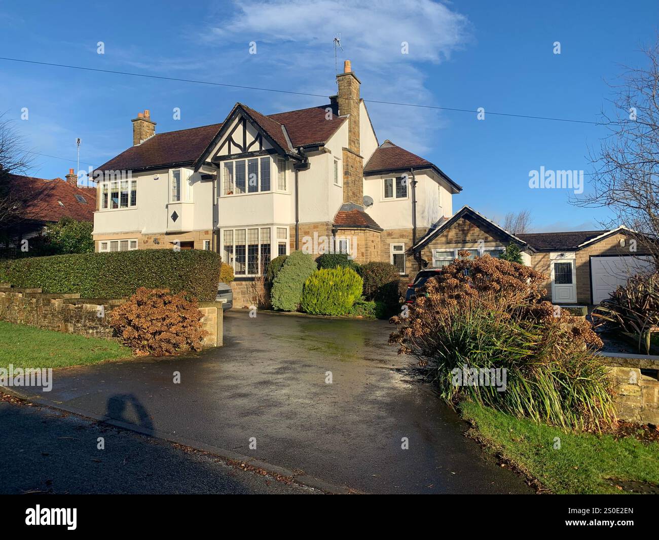Guiseley North Yorkshire houses trees place town village countryside place sky weather Winter Christmas day place bleak clouds England old types - Smartphone Captured Stock Image