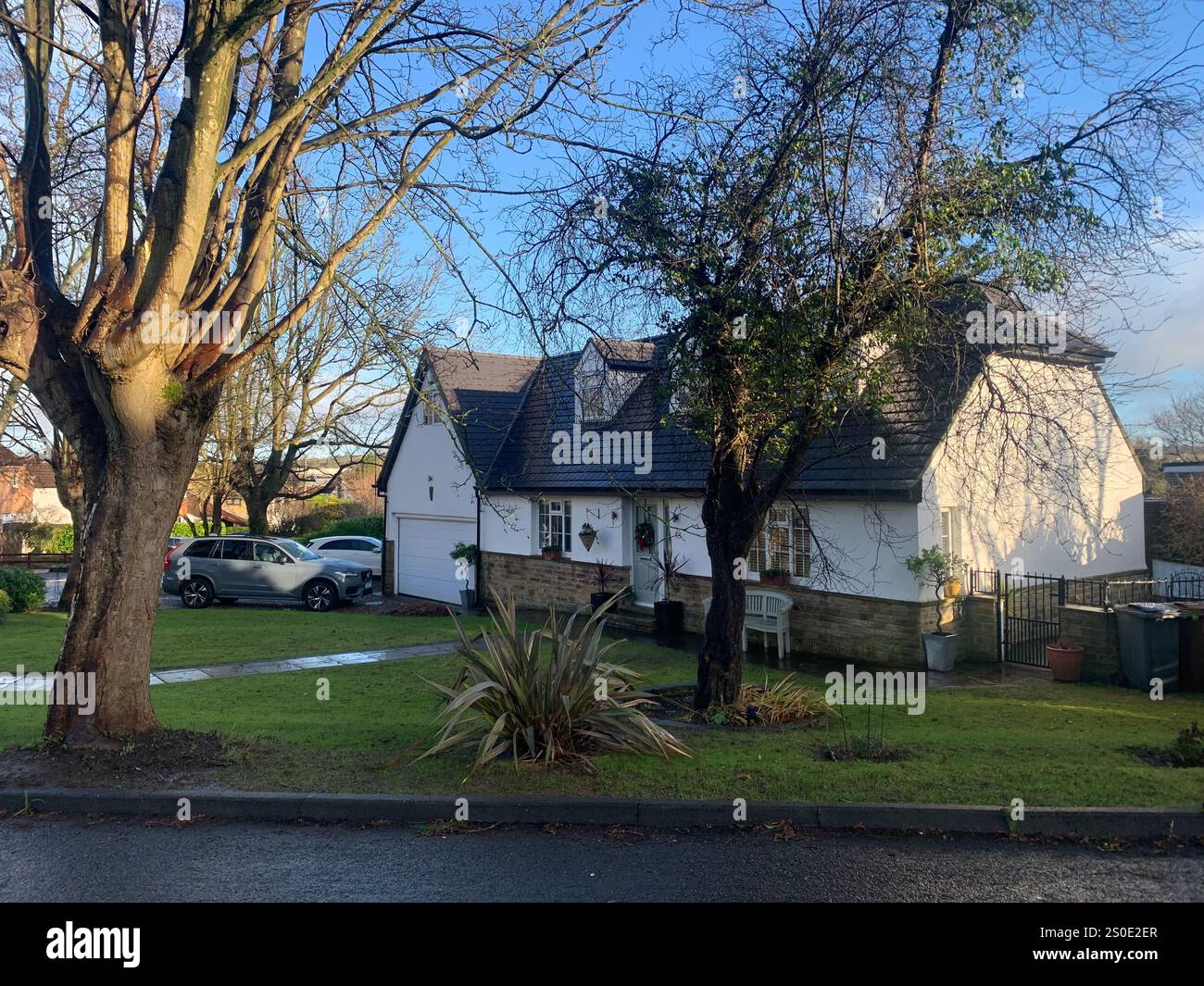 Guiseley North Yorkshire houses trees place town village countryside place sky weather Winter Christmas day place bleak clouds England old types - Smartphone Captured Stock Image
