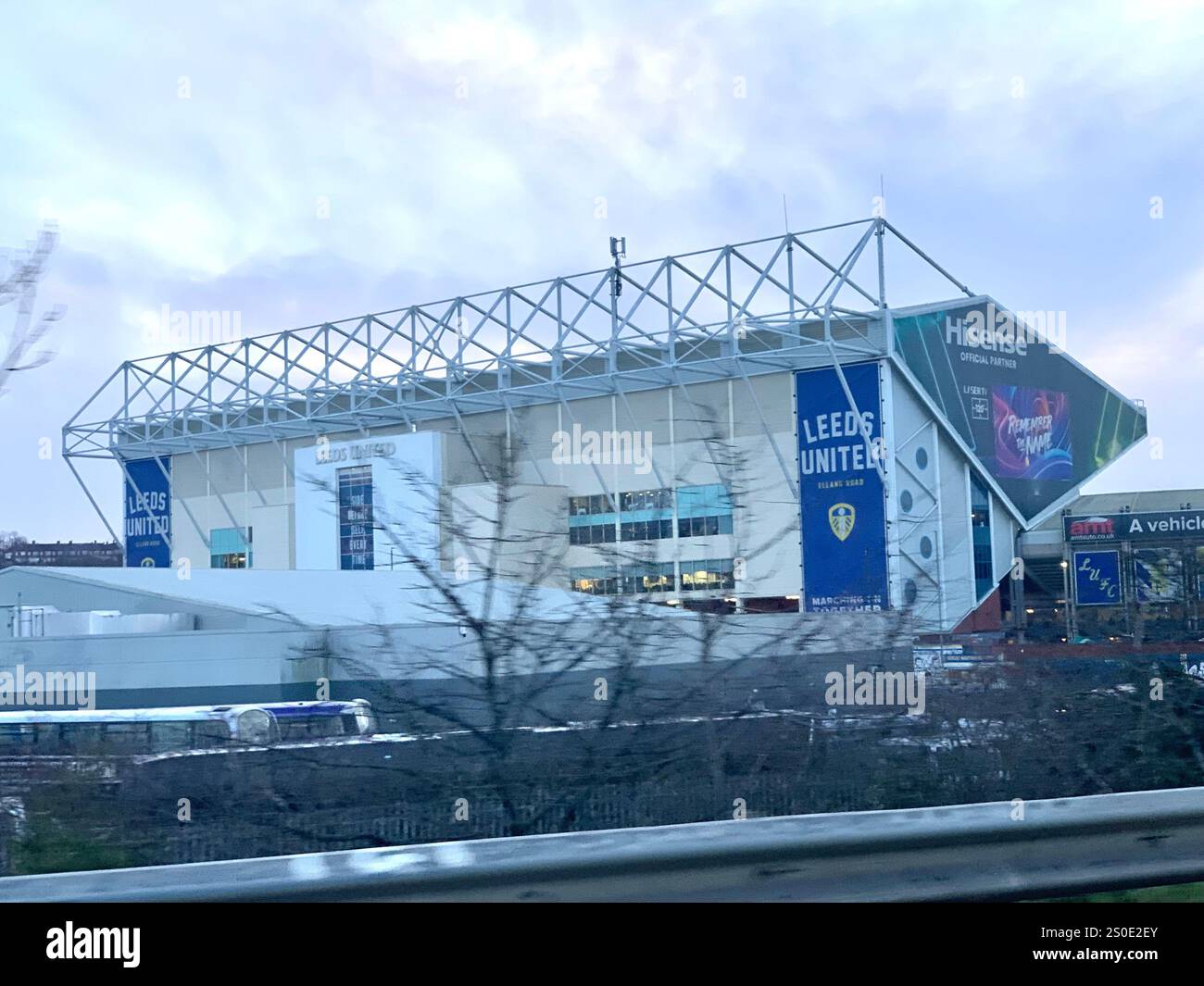 Leeds United football club building play players frame outside sport sporty TV sign signs Hisense post poster play players playing footy wall  games - Smartphone Captured Stock Image