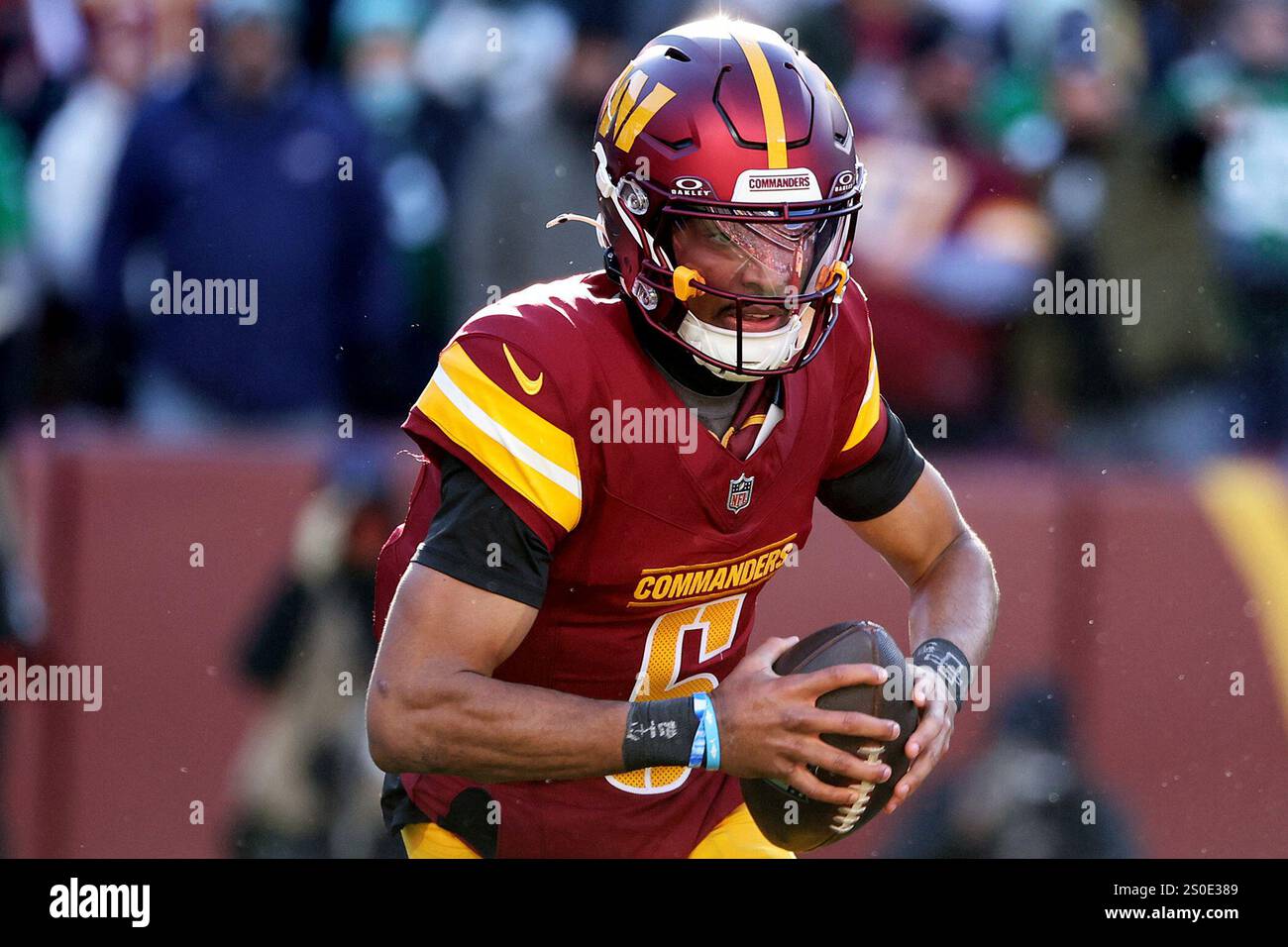 Washington Commanders quarterback Jayden Daniels (5) runs with the ball