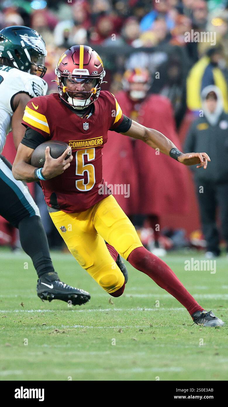 Washington Commanders quarterback Jayden Daniels (5) runs with the ball