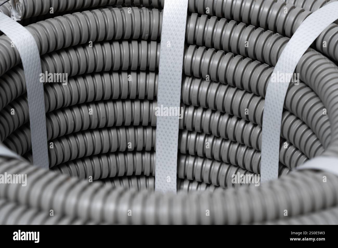 Grey, plastic corrugated pipes . Industrial background Stock Photo