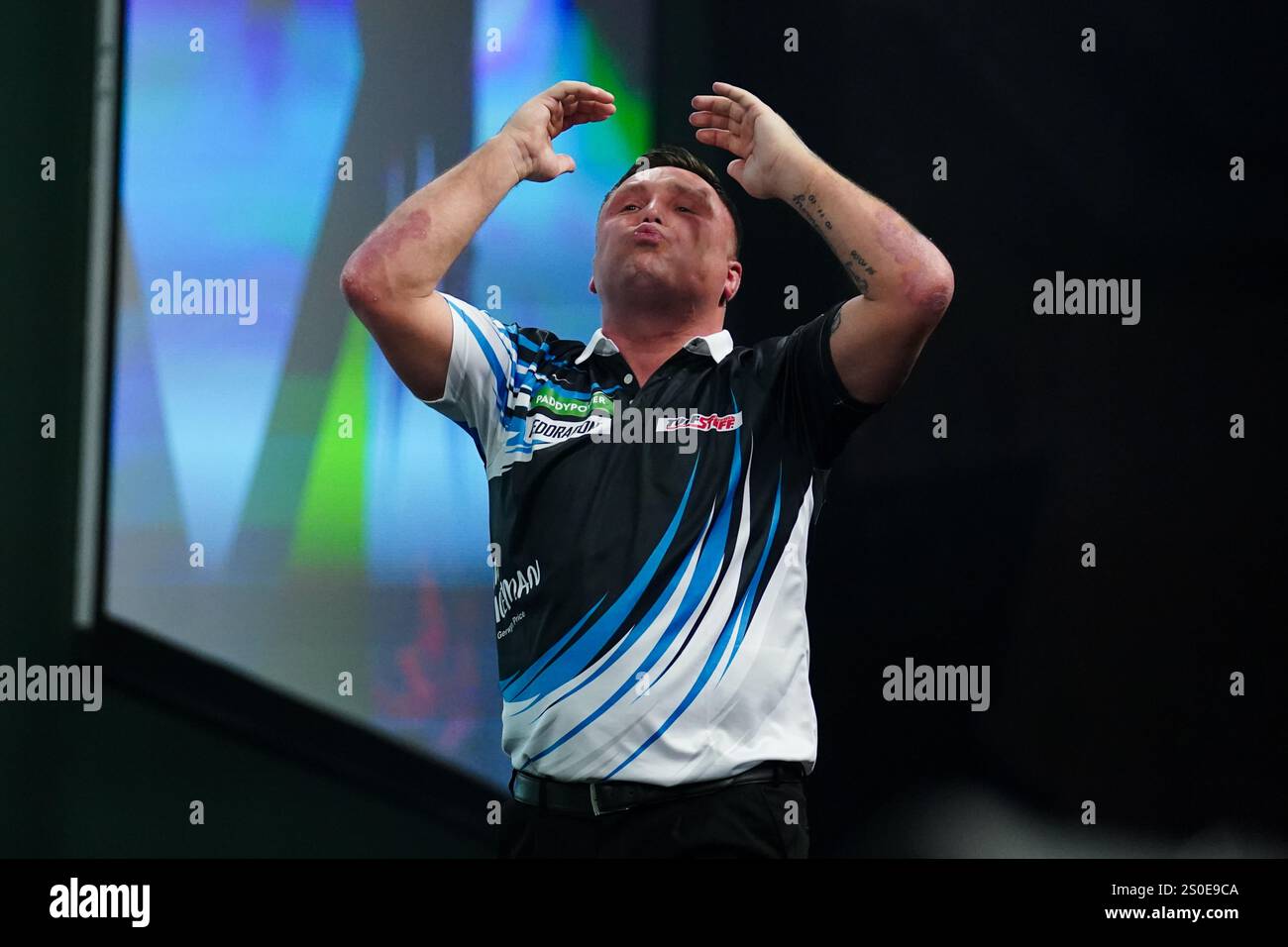 Gerwyn Price celebrating winning during the 3rd round match between