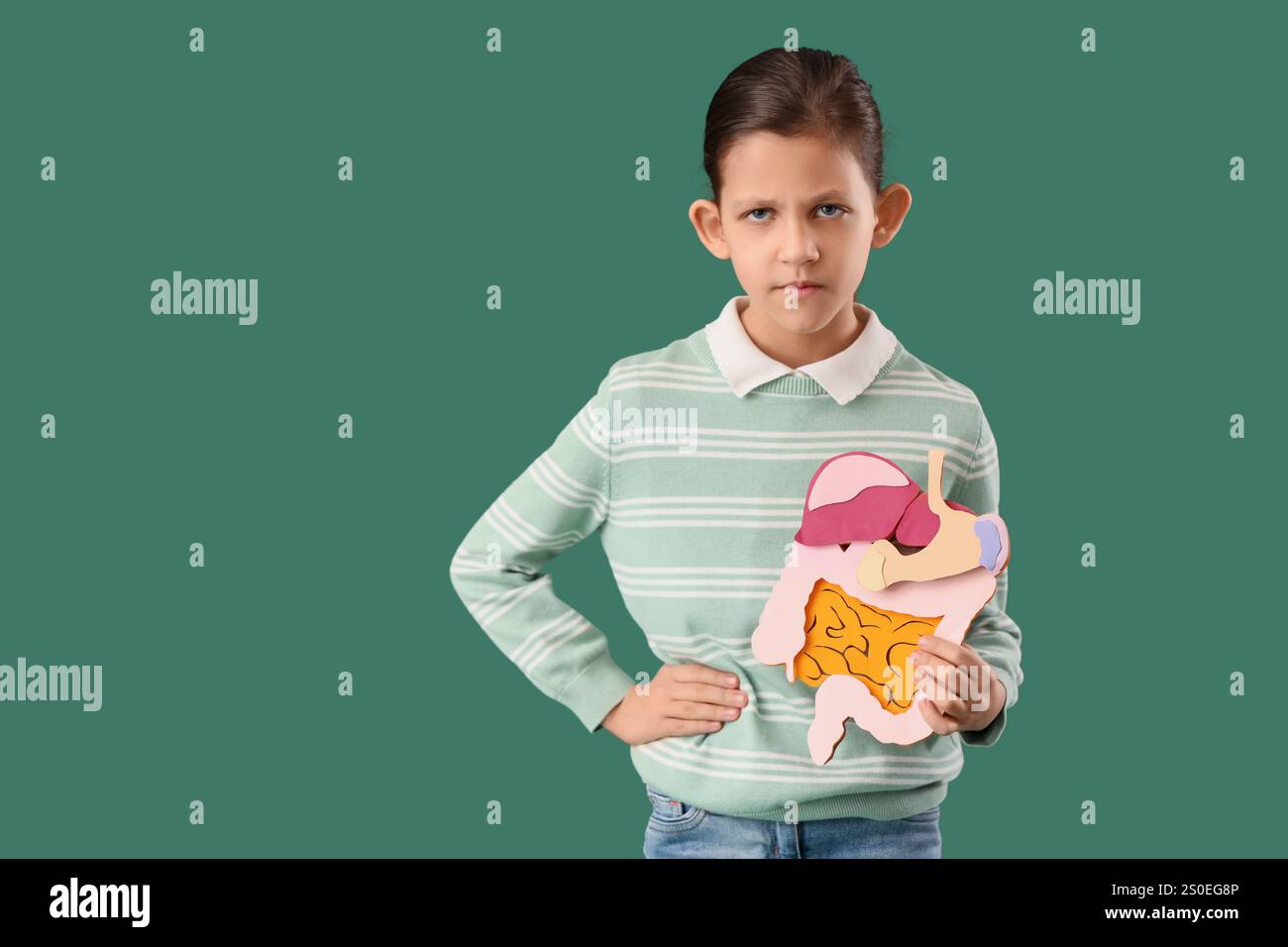 Teenage girl with appendicitis and paper digestive system on green ...