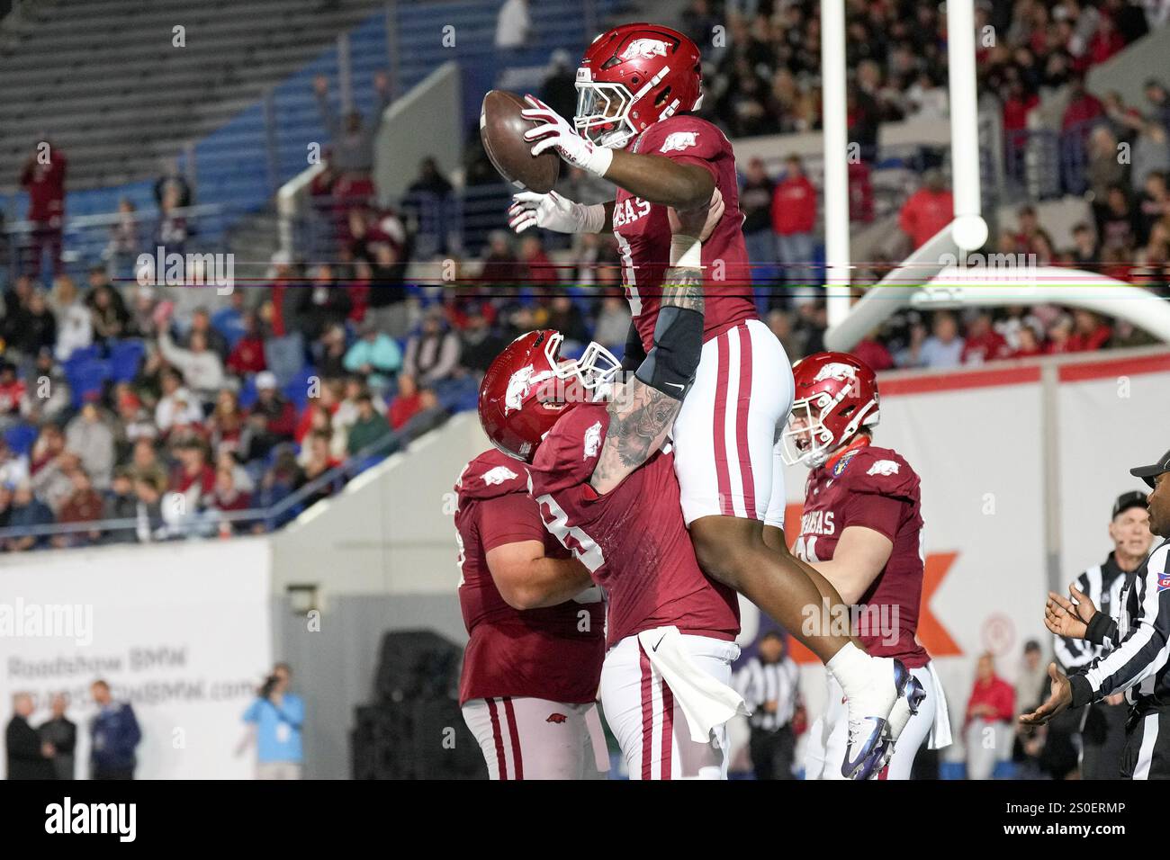 Arkansas running back Braylen Russell, top, celebrates his touchdown