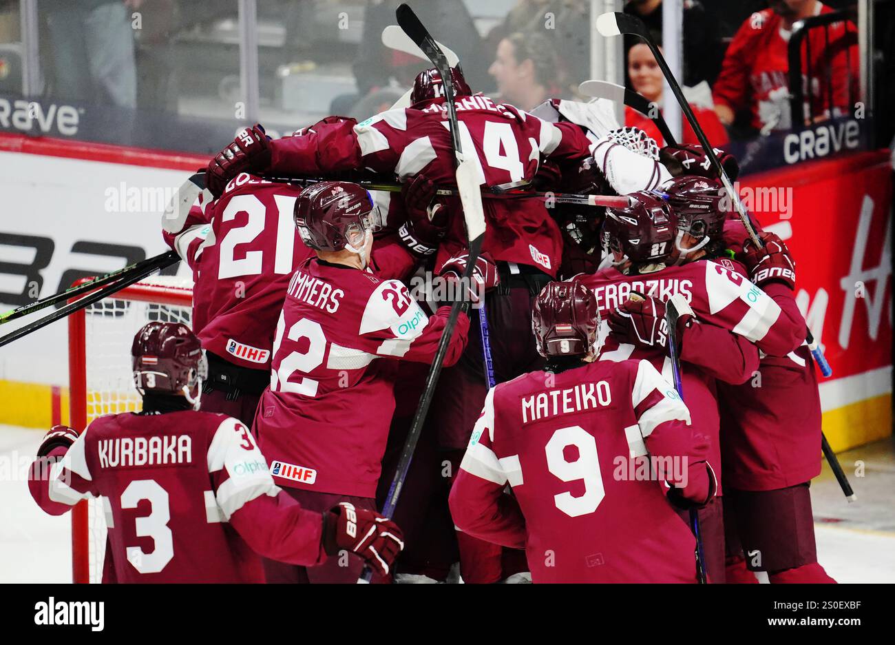 Latvia players celebrate after defeating Canada in shootout IIHF World