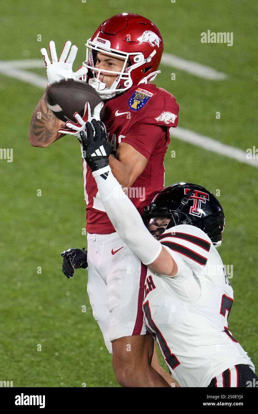 Joe Plunk Arkansas wide receiver CJ Brown, left, makes a catch over Texas Tech ...