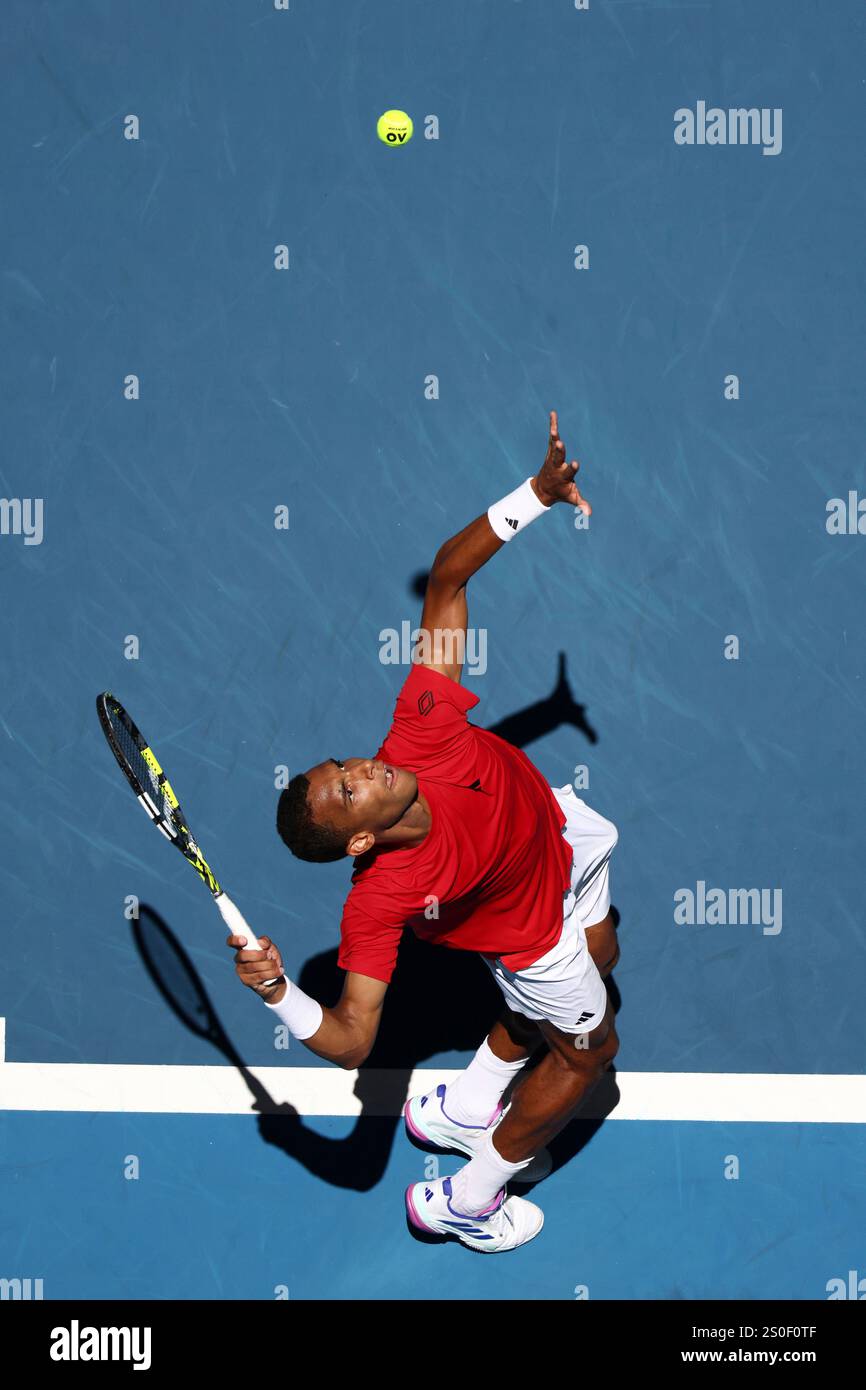 Felix AugerAliassime of Canada serves to opponent Borna Coric of