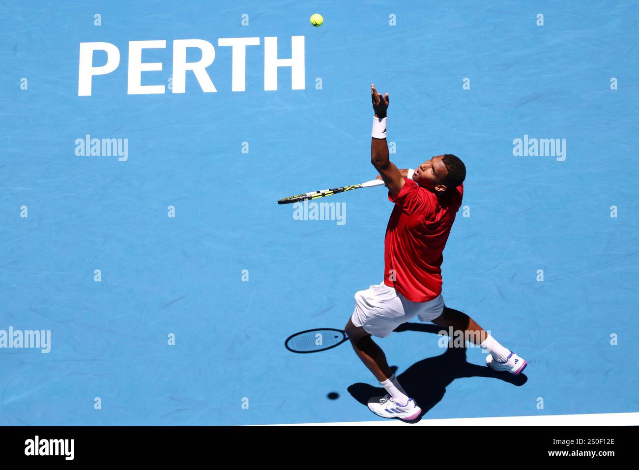 Felix AugerAliassime of Canada serves to opponent Borna Coric of