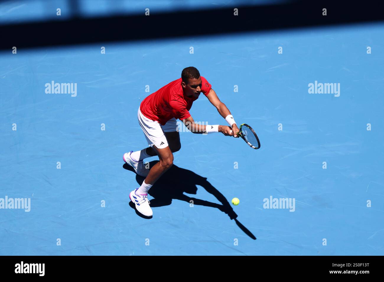 Felix AugerAliassime of Canada returns a shot to opponent Borna Coric