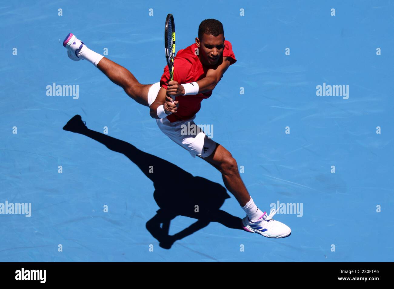 Felix AugerAliassime of Canada returns a shot to opponent Borna Coric