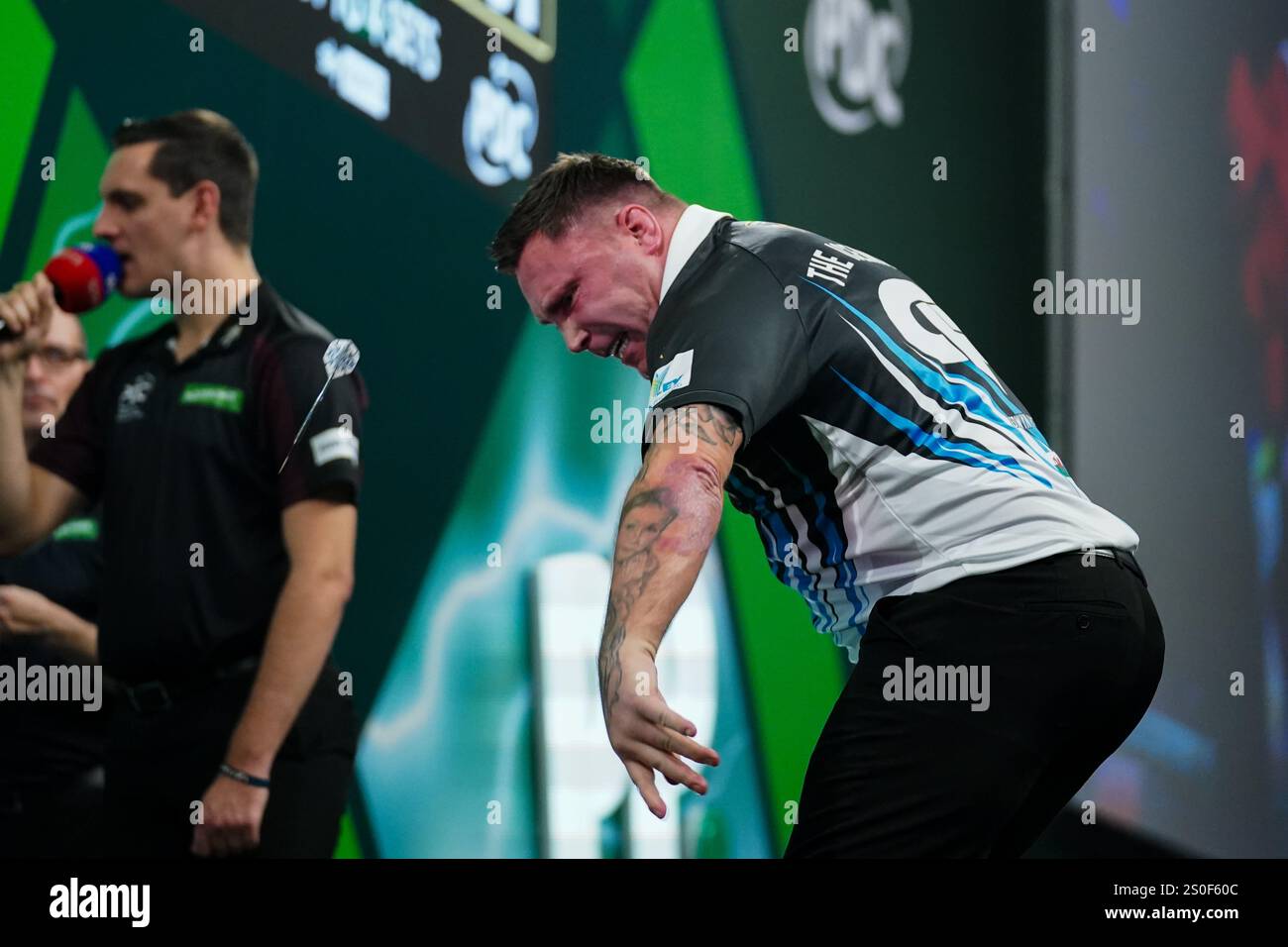 Gerwyn Price throwing his spare dart after winning the 3rd round match