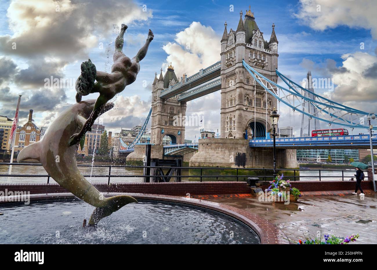 Girl with Dolphin fountain on the north bank of the Thames river, Tower Bridge, London, England, UK Stock Photo