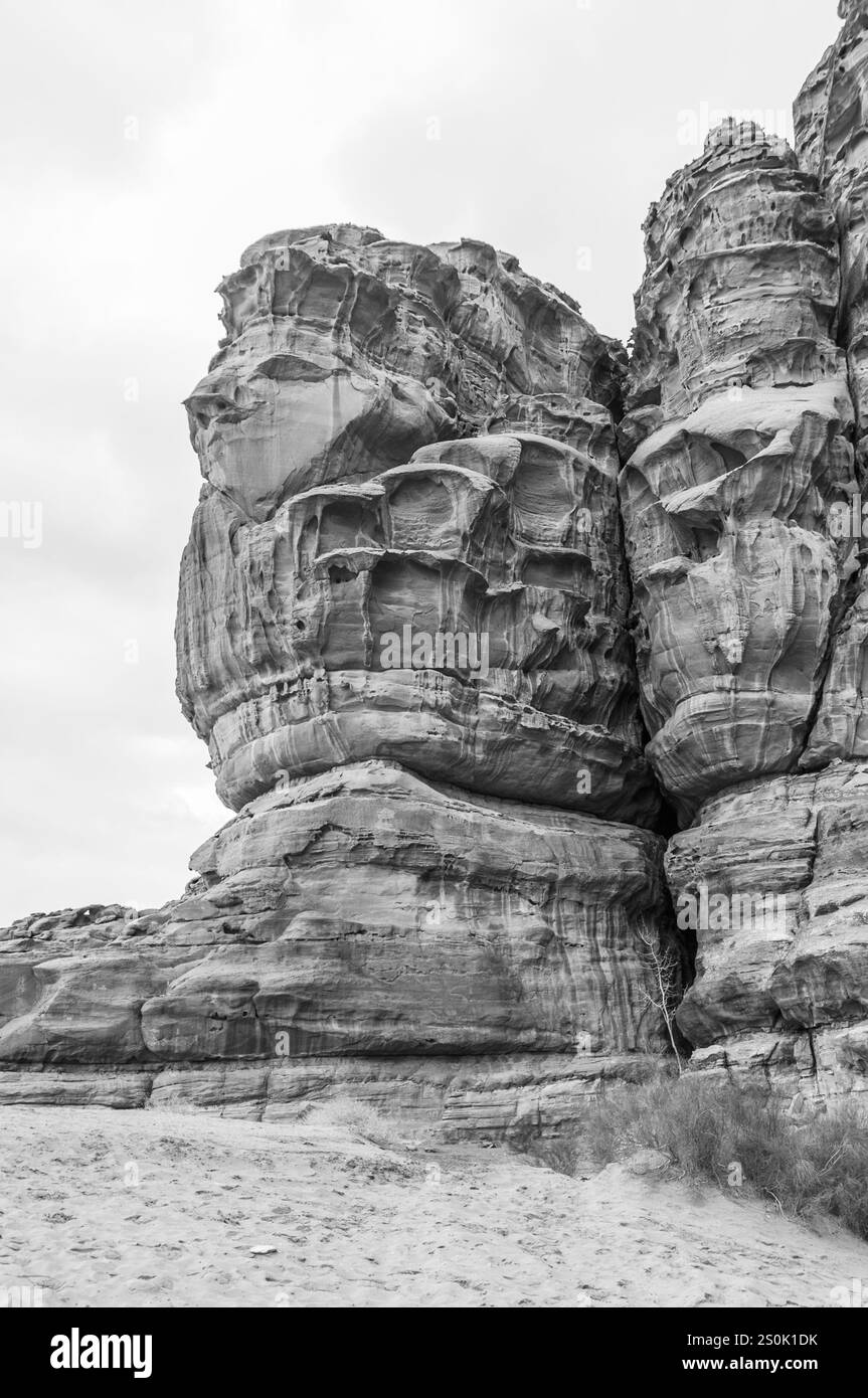 A large rock formation with a face carved into it. The face is carved ...