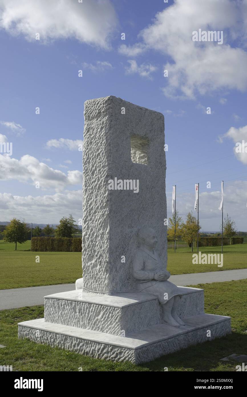 Wuerth Museum 2, White stone sculpture of a seated person in a park ...