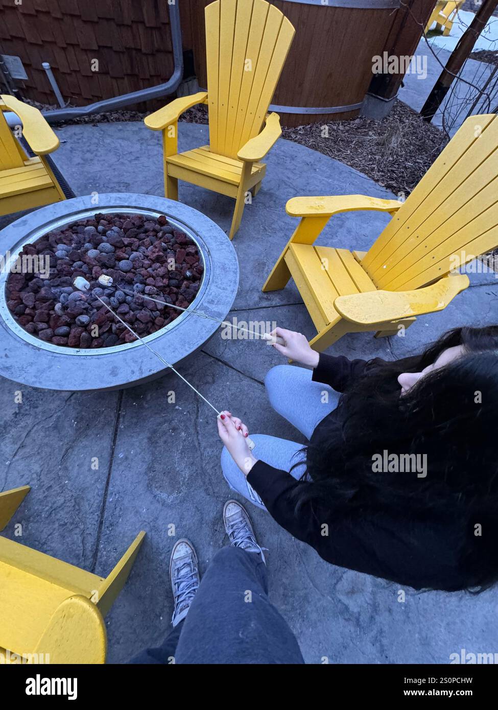 toasting marshmallow's for s'mores around a fire in Banff national park, Alberta, Canada - Smartphone Captured Stock Image