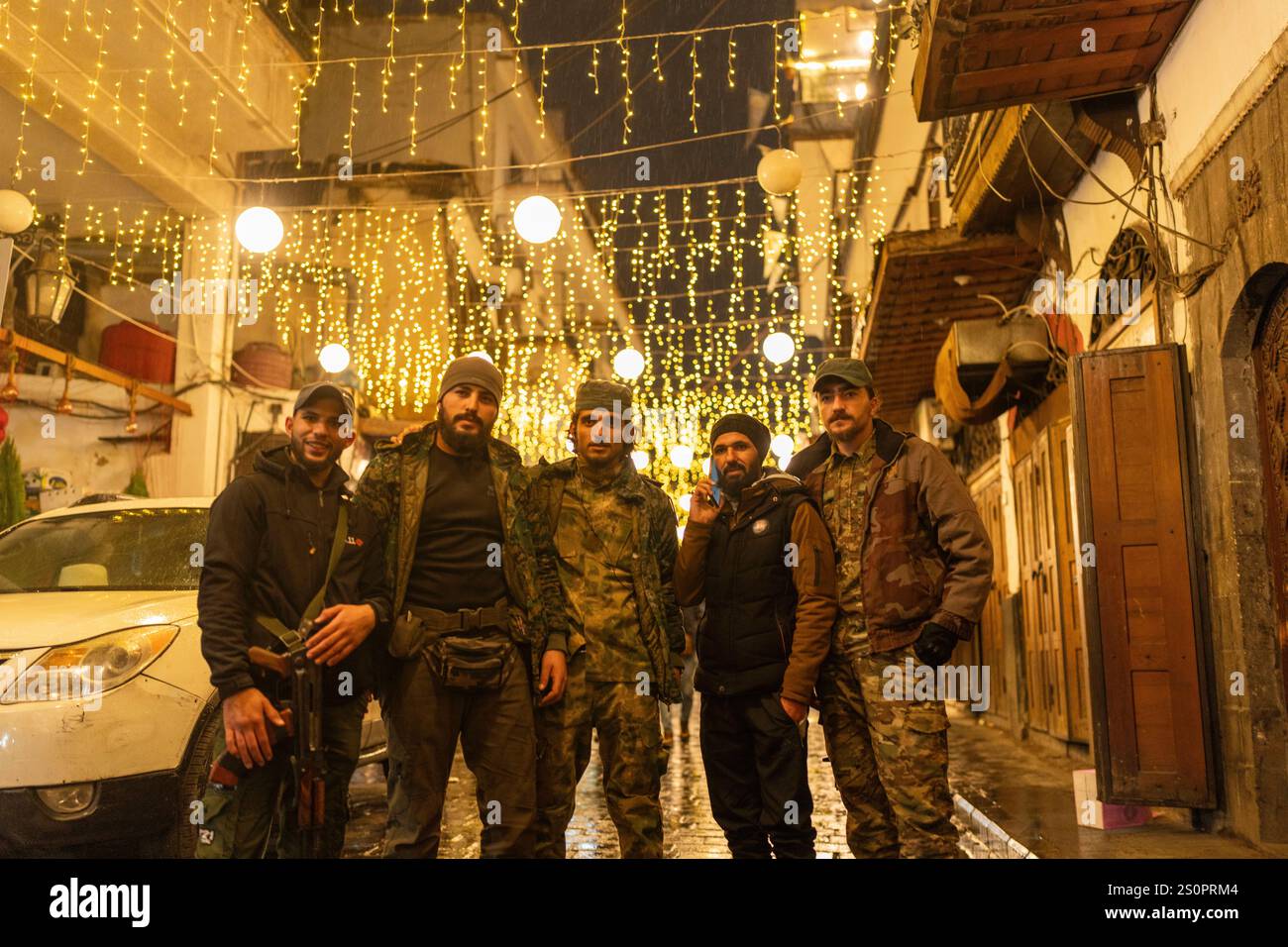Members of the HTS rebel group that overthrew the Assad regime pose for ...