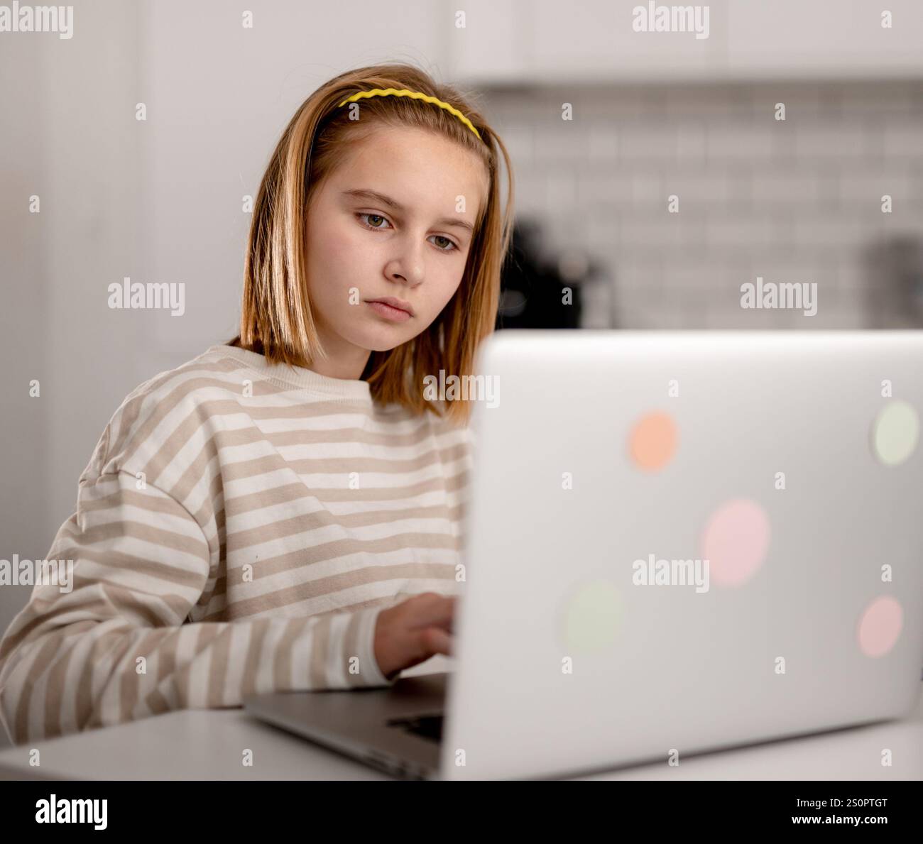 Cute Little Girl Using A Laptop At Home And Browsing The Internet And ...