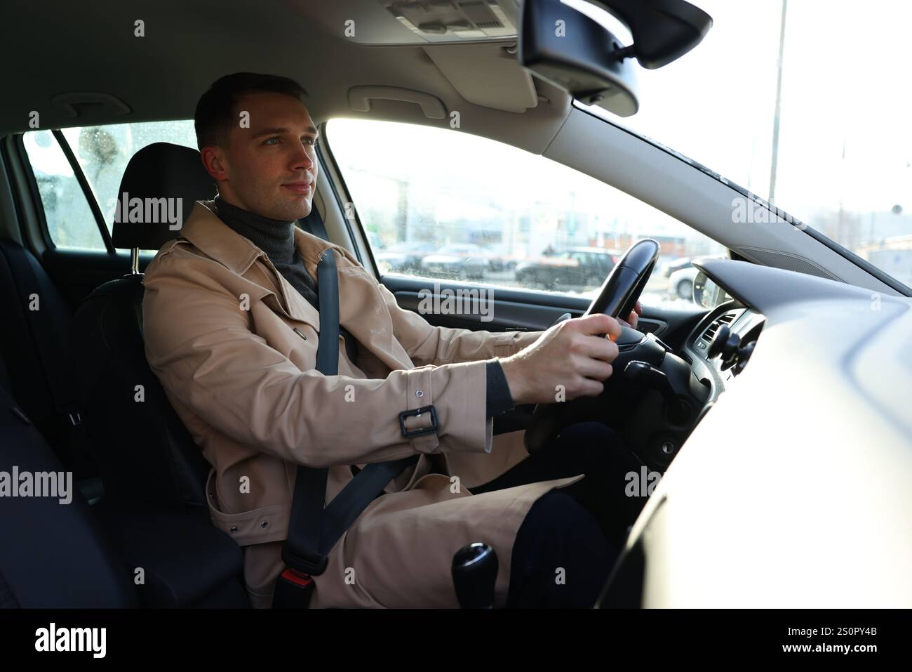 Driver behind steering wheel of modern car Stock Photo - Alamy
