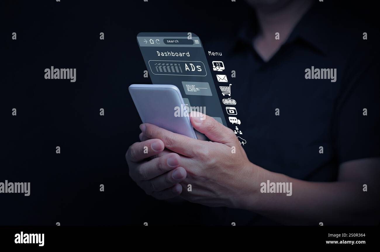 Digital marketing and advertising. A man works on online advertisement and digital ad, using his smartphone. Stock Photo