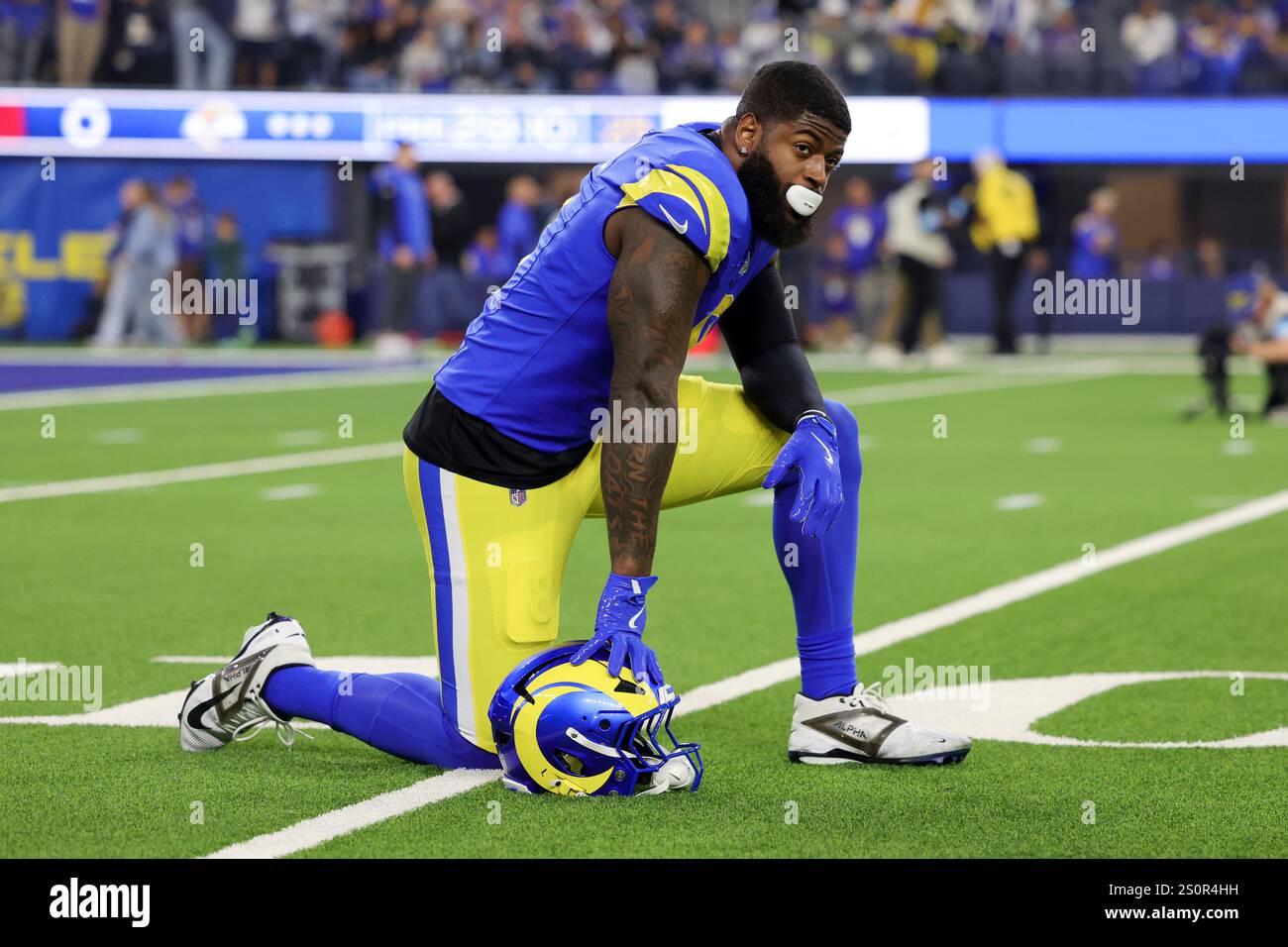 Los Angeles Rams linebacker Jared Verse kneels on the field before an ...